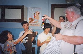 Vikki gives dolls to the Vietnamese orphanage children.